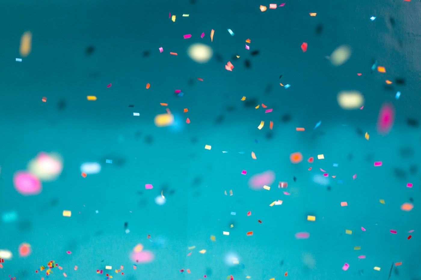 Bright confetti against a turquoise background